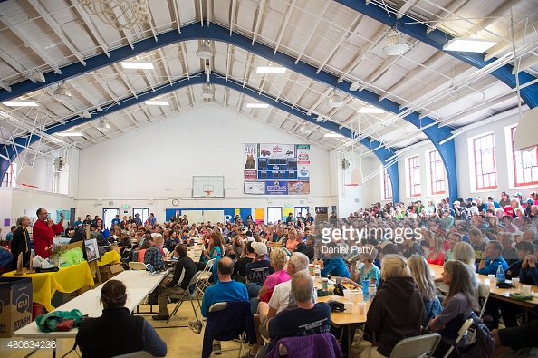 480634236-runners-crew-volunteers-and-staff-sit-in-the-gettyimages